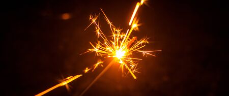 Sparklers for Christmas and New Year close-up in the form of a banner and on a black backgroundの写真素材