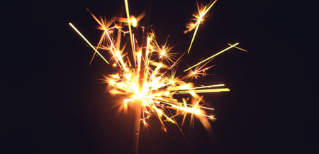 Bright sparklers for Christmas and New Year close-up in the form of a banner and on a black...