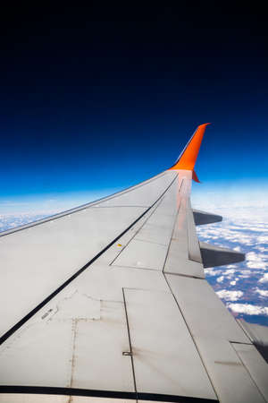 Flying to another country, traveling by plane, first flight, the ground down, preparing the plane for flight, beautiful landscapes from the windowの写真素材