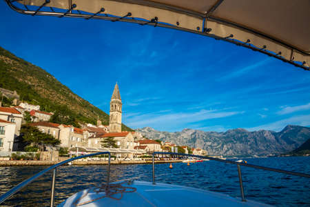 A trip to the tourist old town of the Adriatic coast Perast in Montenegro among the mountains and with beautiful old buildings with red tiles, there are many cafes in the city, narrow streets and clean air with seagulls and catsの写真素材