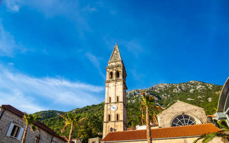 A trip to the tourist old town of the Adriatic coast Perast in Montenegro among the mountains and with beautiful old buildings with red tiles, there are many cafes in the city, narrow streets and clean air with seagulls and catsの写真素材