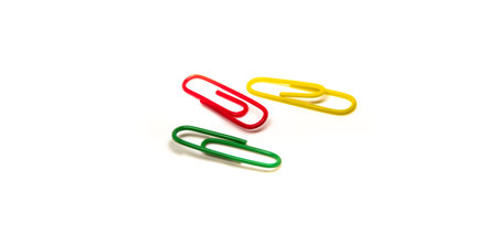 Red paper clip attached to multiple sheets of paper.