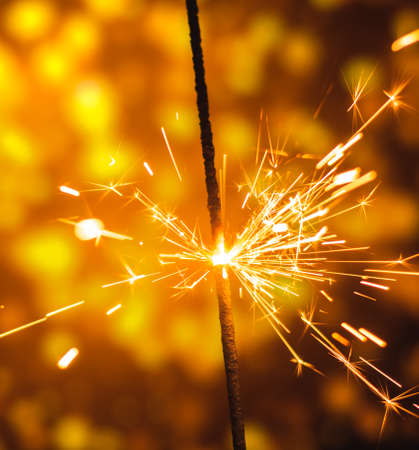 A series of photographs for the holiday New Years and Christmas sparklers on a bright beautiful background and bokehの写真素材