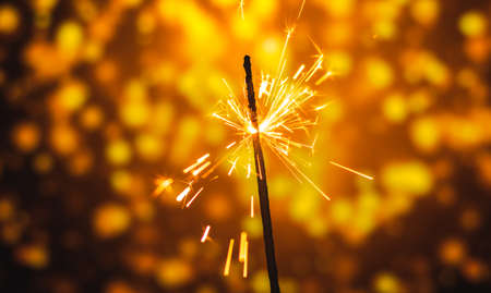 A series of photographs for the holiday New Years and Christmas sparklers on a bright beautiful background and bokehの写真素材
