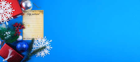 Green Christmas presents with snow on gray wooden background for a greeting card or coupon, voucherの写真素材