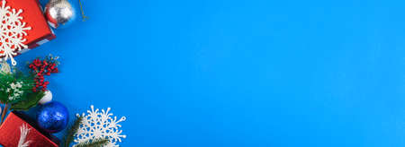 Green Christmas presents with snow on gray wooden background for a greeting card or coupon, voucherの写真素材