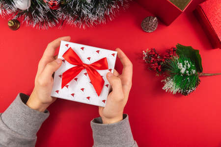 A series of New Year's photos on a beautiful red background on the theme of the COVID virus, take care of yourself, masks in the photo, gifts for Christmasの写真素材