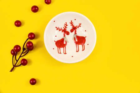 A series of beautiful conceptual photographs on a yellow and orange background for a christmas and new year etmu, pine cones, fir branches, top view, templates and banners with gifts and a notebookの写真素材