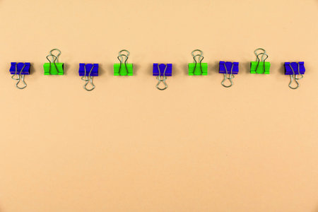 Office supplies on bright beautiful pleasant backgrounds, paper clips and other tools necessary for...