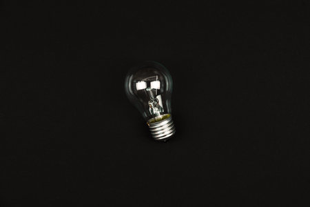 turn on tungsten light bulb, Realistic photo image Glowing yellow light bulb isolated on white backgroundの写真素材
