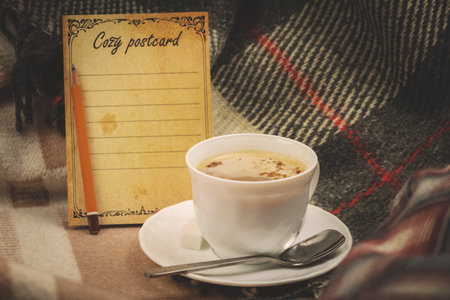 Cozy winter composition, a cup of hot drink in a service set, postcard with place for text photoの写真素材