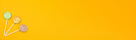 Banner with round lollipops, candy and unhealthy food concept, copy space, design, top view concept...