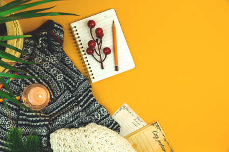 Winter holidays greeting card, postcards, cozy poster template, woolen and knitted sweater, candle, copy spaceの写真素材