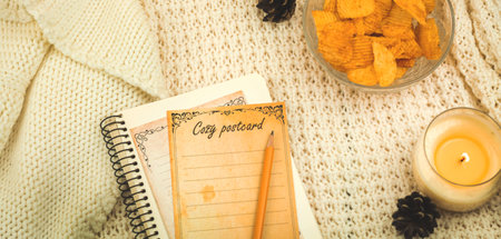 Cozy home banner on winter holiday, copy space template, food, candle and postcard, composition for bloggers, photoの写真素材