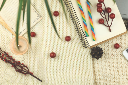 Flat lay composition, winter cozy background with food, candy and decorations, workplace or workspace at holiday, copy space photoの写真素材