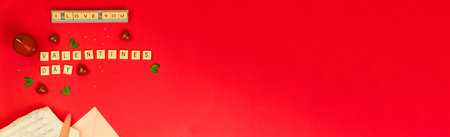 Wide Valentine's day celebration banner with letters and word on red flat background with copy...