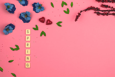 Spring beauty background, flat lay and top view on a vibrant pink with decorative flowers and lettering, copy space photoの写真素材