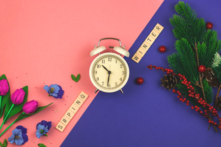 Change of season of the year theme, creative concept of winter and spring changing with decorative flowers, flat lay background. High quality photoの写真素材