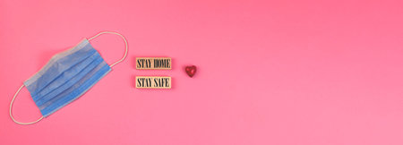 Stay home and be safe valentine's day theme concept banner with a red heart and medical mask photo