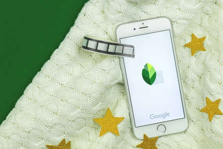 Kharkov, Ukraine - February 5, 2021: close up of Snapseed mobile app icon on a smartphone Apple, professional photo editing application by Google, creative flat lay background, banner copy space photoのeditorial素材