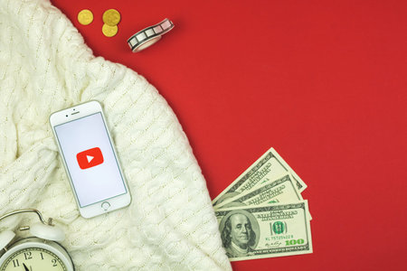 Kharkov, Ukraine - February 5, 2021: Youtube on Apple smartphone screen, creative background, flat...