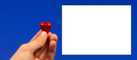 Happy Valentines Day greeting card mockup banner, red hearts in boys hand, blue background and copy...