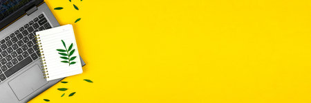 Spring office design, flat lay composition with laptop and blank notepad on yellow background,...