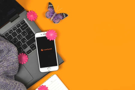 Kharkov, Ukraine - February 22, 2021: anime app Crunchyroll on Apple smartphone screen, logotype, creative banner, copy space, orange background photoのeditorial素材