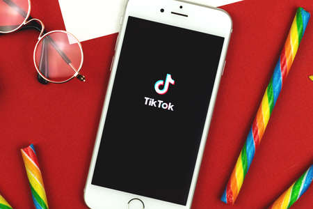 Kharkov, Ukraine - February 22, 2021: Tiktok logo on Apple smartphone screen, creative background photoのeditorial素材
