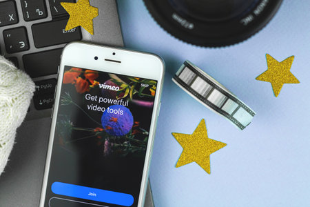 Kharkov, Ukraine - February 22, 2021: Vimeo application title screen close up on Apple smartphone, creative flat lay composition photoのeditorial素材