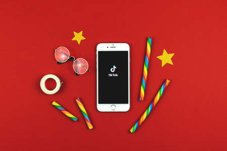 Kharkov, Ukraine - February 22, 2021: Tiktok social media network app on Apple iPhone screen, the youth concept on red background photoのeditorial素材