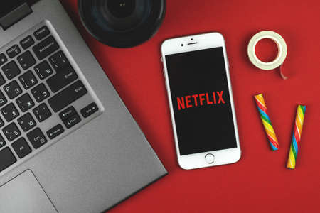 Kharkov, Ukraine - February 22, 2021: Netflix app on smartphone screen, Apple iPhone, creative banner for Netflix, online video streaming subscription service photoのeditorial素材