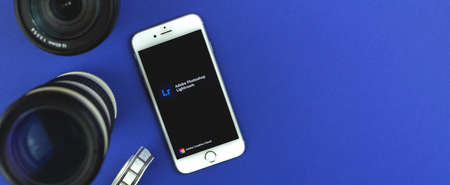 Kharkov, Ukraine - February 22, 2021: Adobe Lightroom application banner, app logo on screen of Apple iPhone smartphone, flat lay and copy space photoのeditorial素材