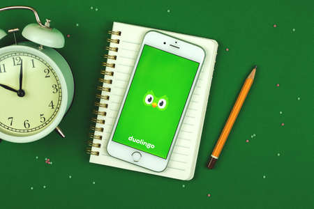 Kharkov, Ukraine - February 22, 2021: Duolingo app on Apple iPhone screen, language learning platform, creative background with application, photoのeditorial素材