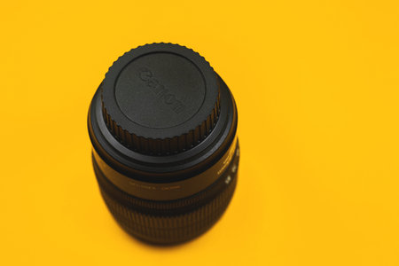 Kharkov, Ukraine - March 7, 2021: Back side of Canon lens with bayonet mount cup, yellow backgroundのeditorial素材
