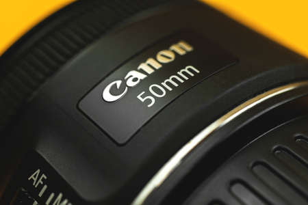 Kharkov, Ukraine - March 7, 2021: Canon 50mm portrait lens close-up with brand logotypeのeditorial素材