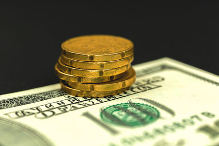 Stack of gold euro coins on banknotes, business and finance concept photo