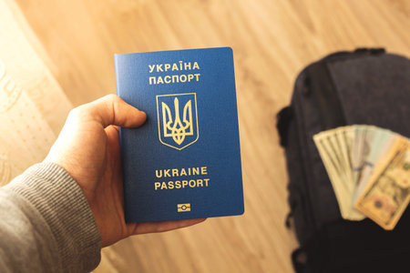 Ukrainian passport for travel, man holds the documentの写真素材