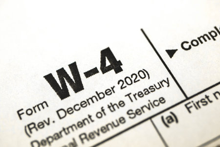 Tax form W-4, tax witholding official document close up, business concept