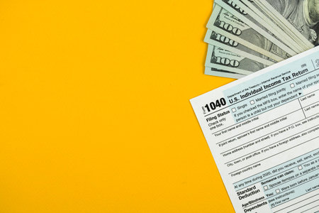 Income tax return concept background, business workspace and desktop, with money or cashの写真素材