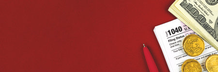 Tax time concept banner with tax from 1040, Income tax return, copy space and red background, office...