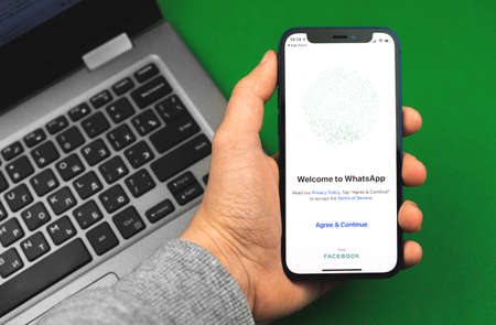 Kharkov, Ukraine - March 9, 2021: Man using Whatsapp application, title screen of the app for messagingのeditorial素材