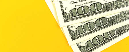 Dollars banner with on hundred US bills on the desk, copy space photoの写真素材