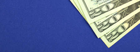 Twenty dollars banner, 20 dollar bills on the office desk, business and financial web concept, blue bakcgroundの写真素材