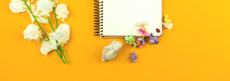 Easter template banner with spring and dried flowers on yellow backgroundの写真素材