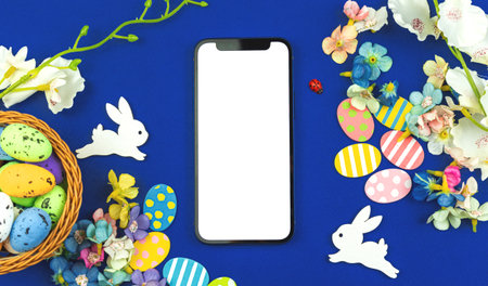 Easter template with blank white screen, modern spring mockup concept with flowers decorationsの写真素材