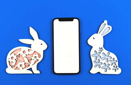 Happy Easter mockup background with place for your text, cute bunny on a blue paper, top view, flat lay photoの写真素材