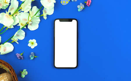 Holiday Easter mockup with smartphone blank white screen with copy spaceの写真素材