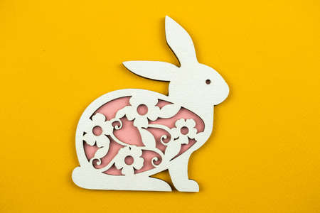 Wooden easter decoration, flat bunny background photoの写真素材