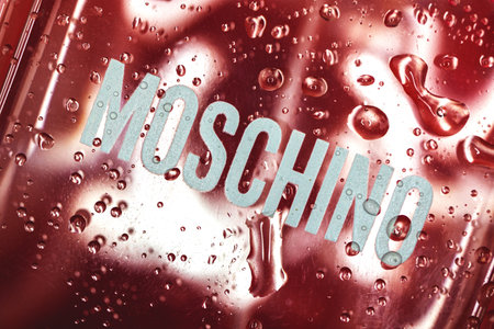 Kharkov, Ukraine - March 23, 2021: Moschino brand logo on glass bottle, with water dropletsのeditorial素材